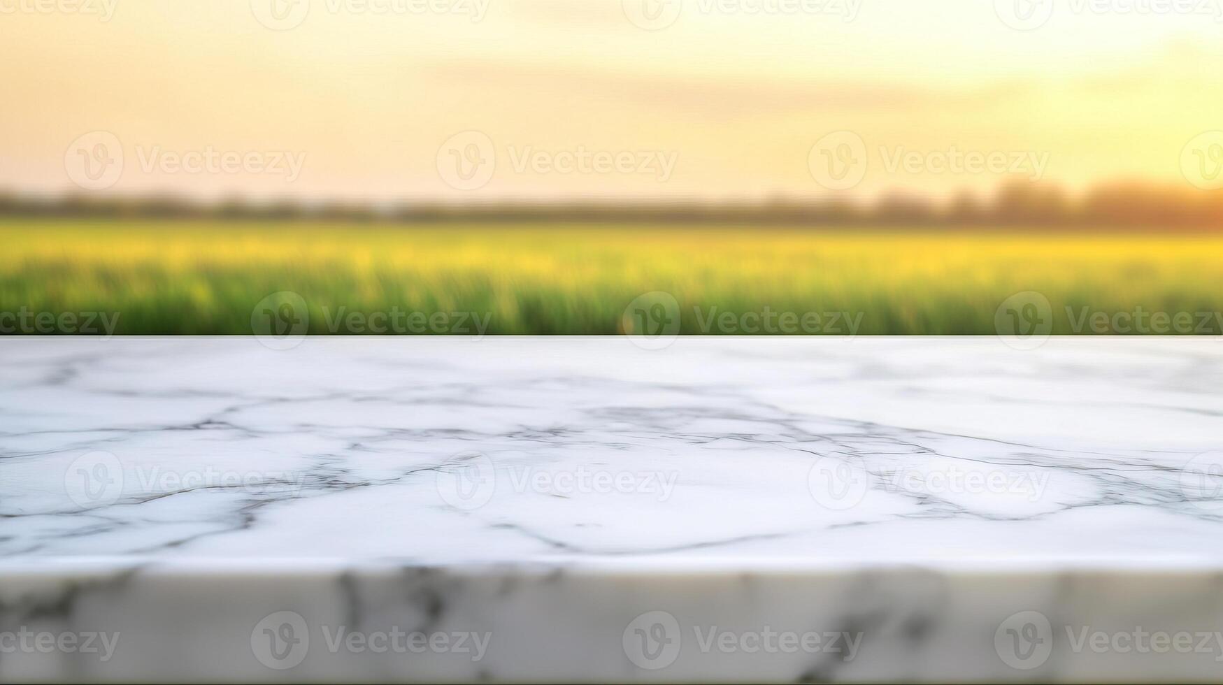 Natural Marble Surfaces with Soft Bokeh Lighting. A serene landscape featuring a blurred sunset over green fields, with a marble countertop in the foreground. photo