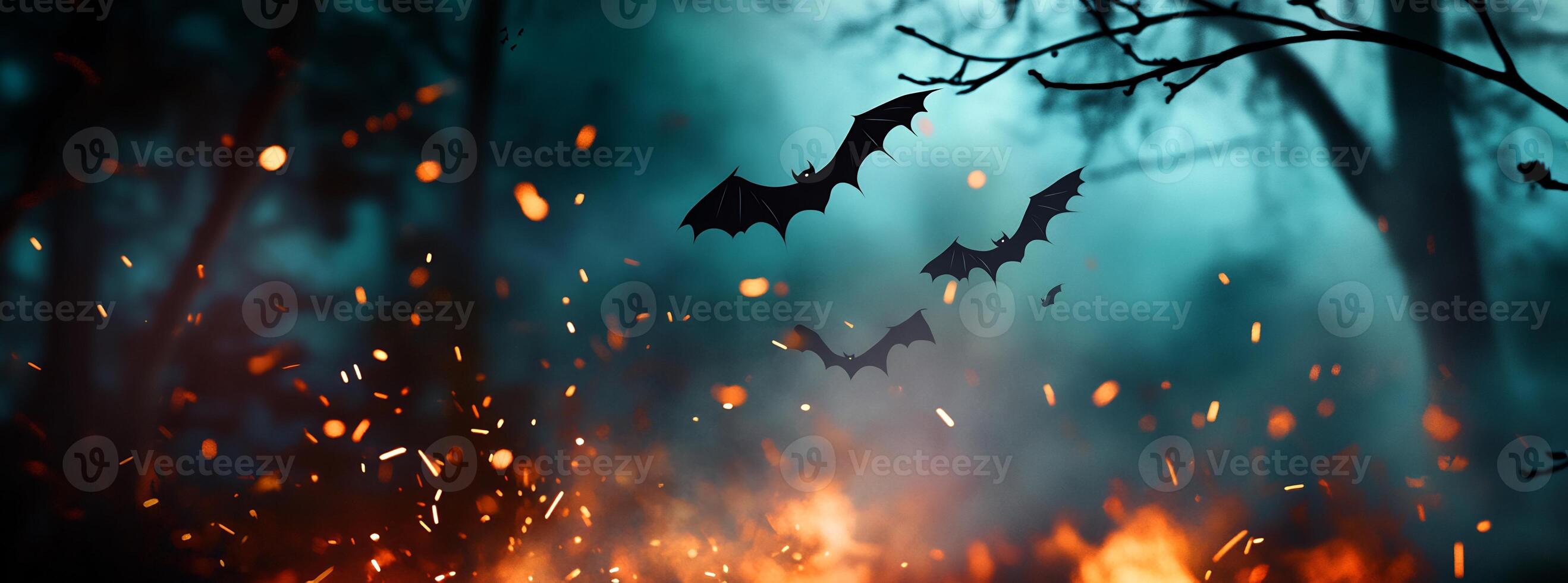 Halloween background with bats flying over a fire photo