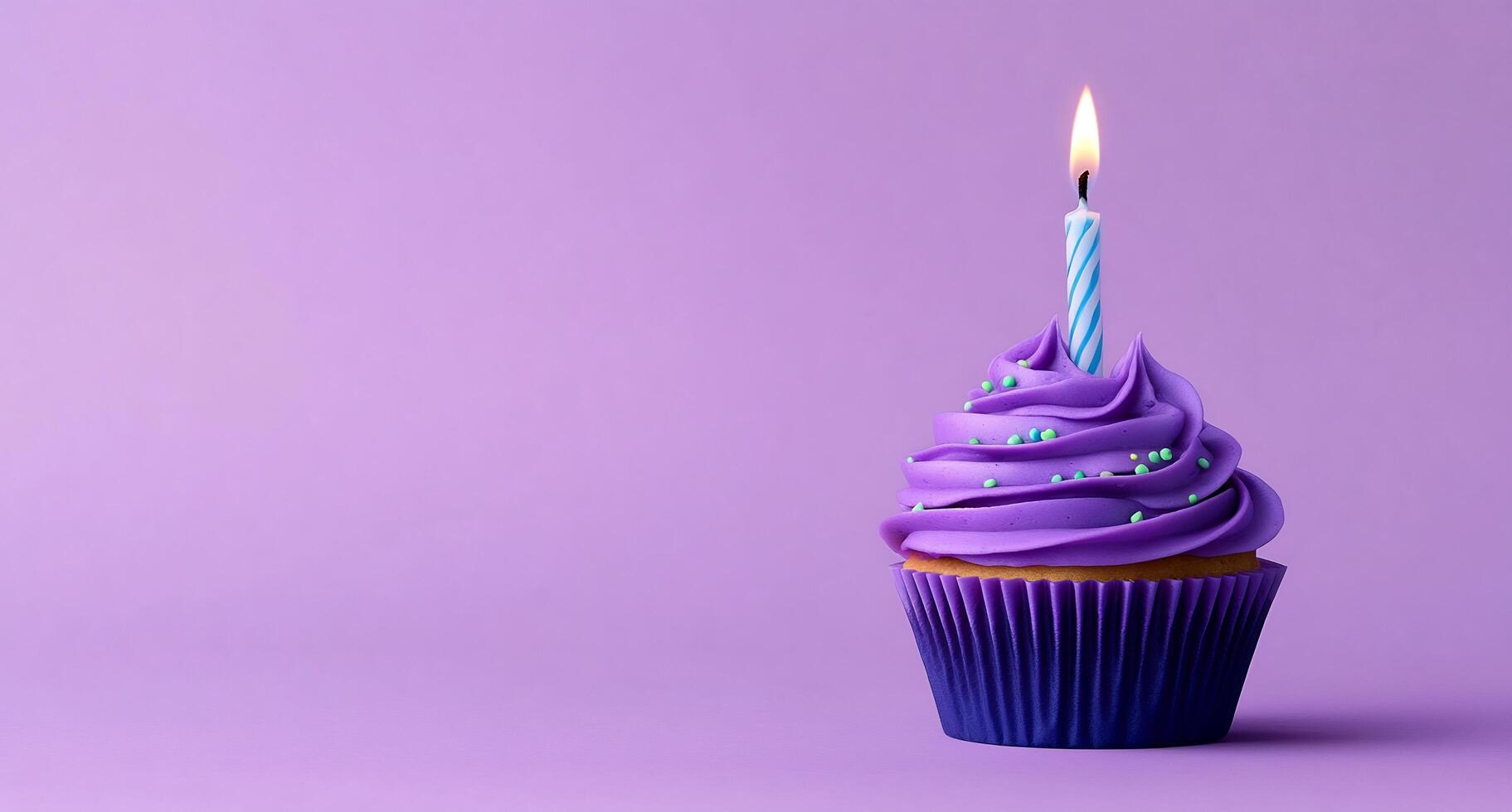 A cupcake with a single candle on a purple background photo