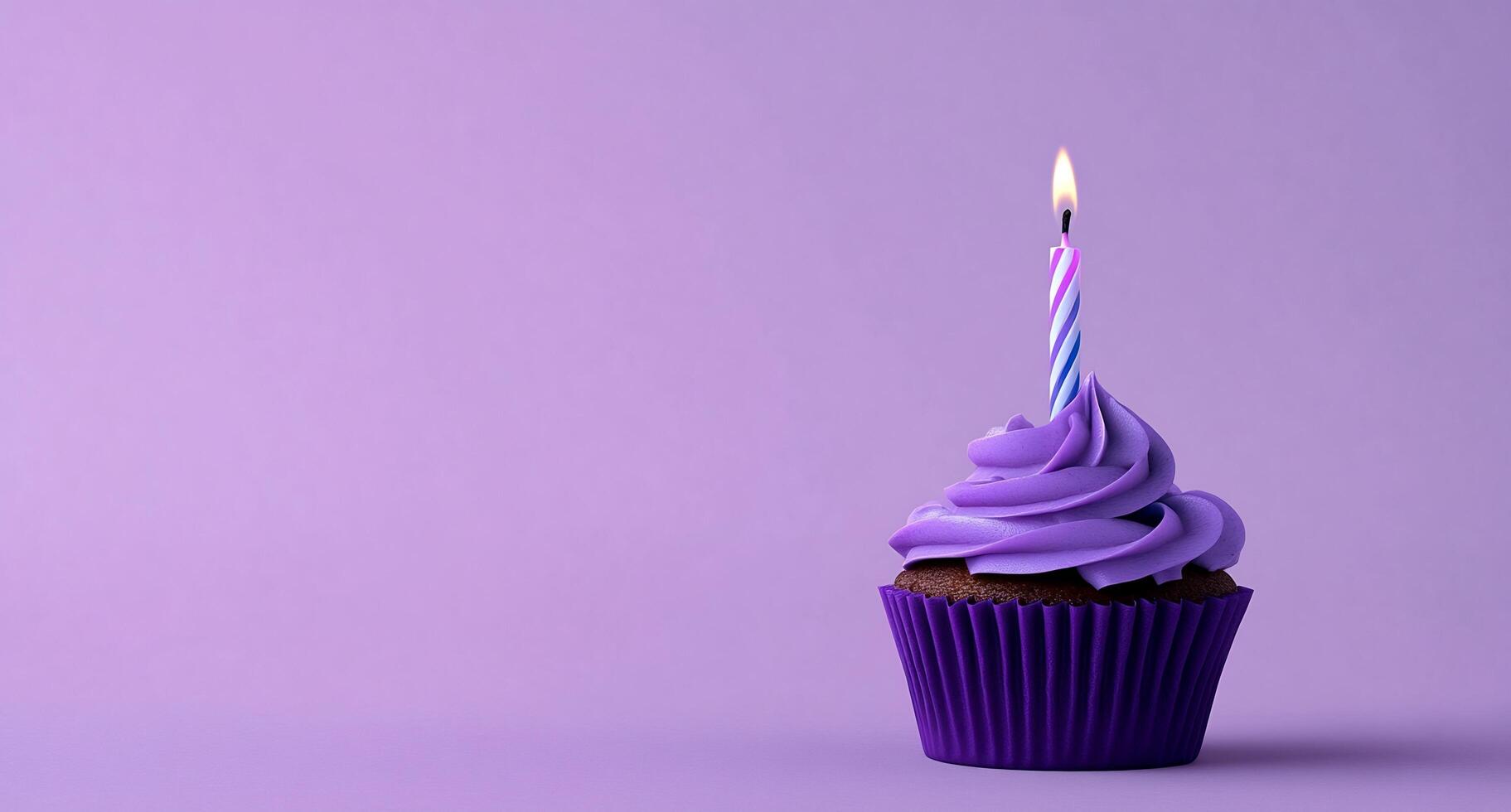 A cupcake with a purple frosting and a single candle photo