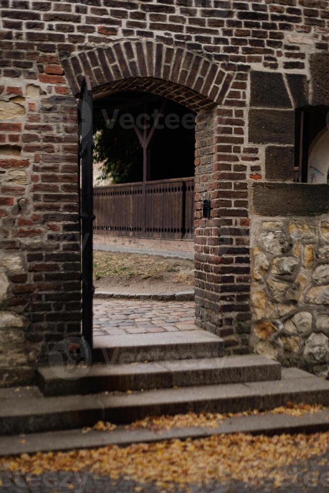 Old brick archway opening to tranquil courtyard in autumn in Vysehrad Prague photo