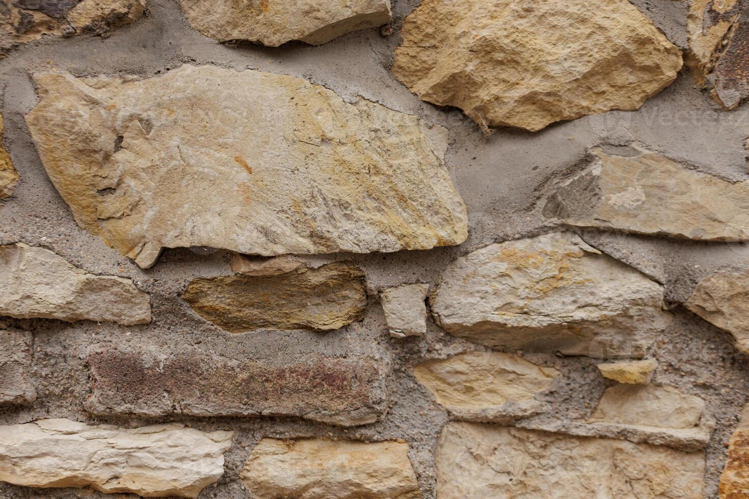 Stone wall showing rough surface texture background in Vysehrad Prague photo