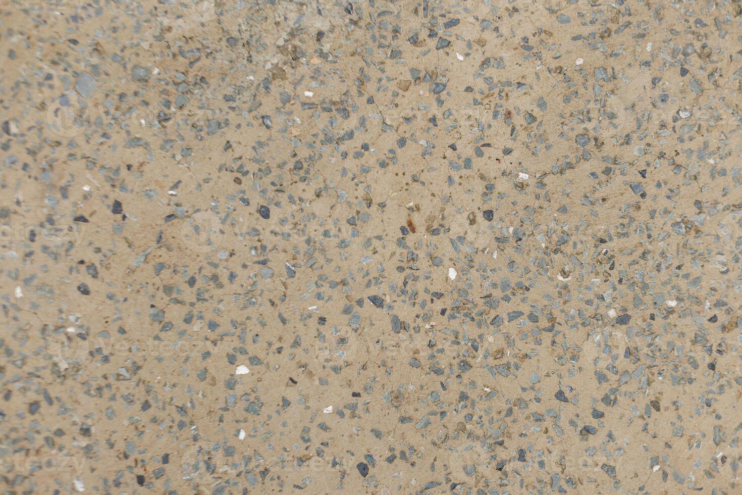 Close up view of small stones embedded in the cement Karlin, Prague photo