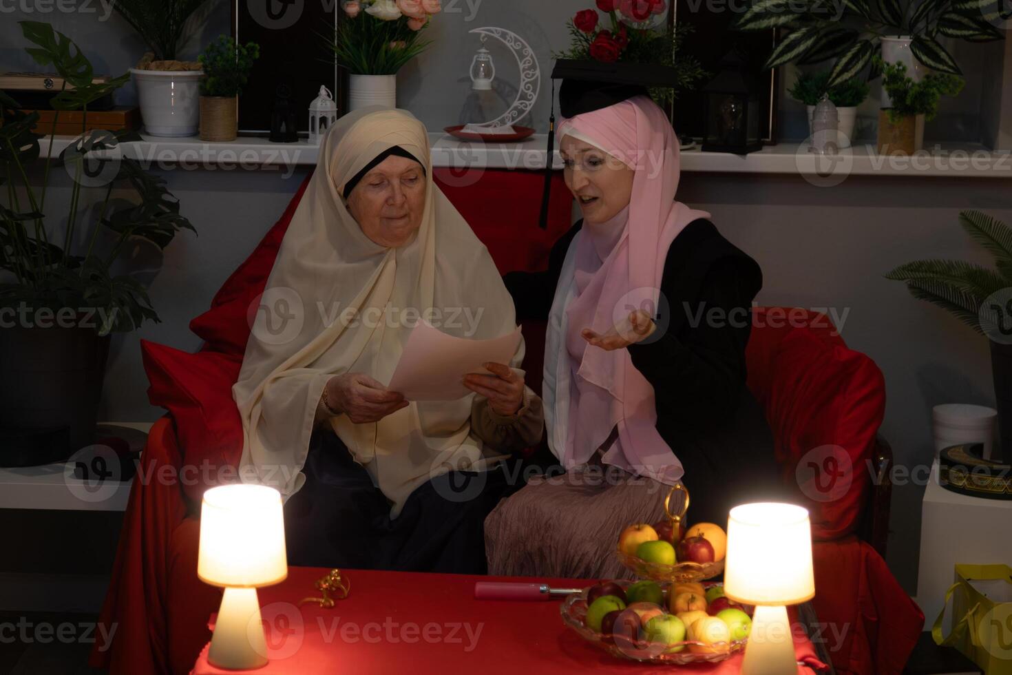 Two women sitting on a couch photo