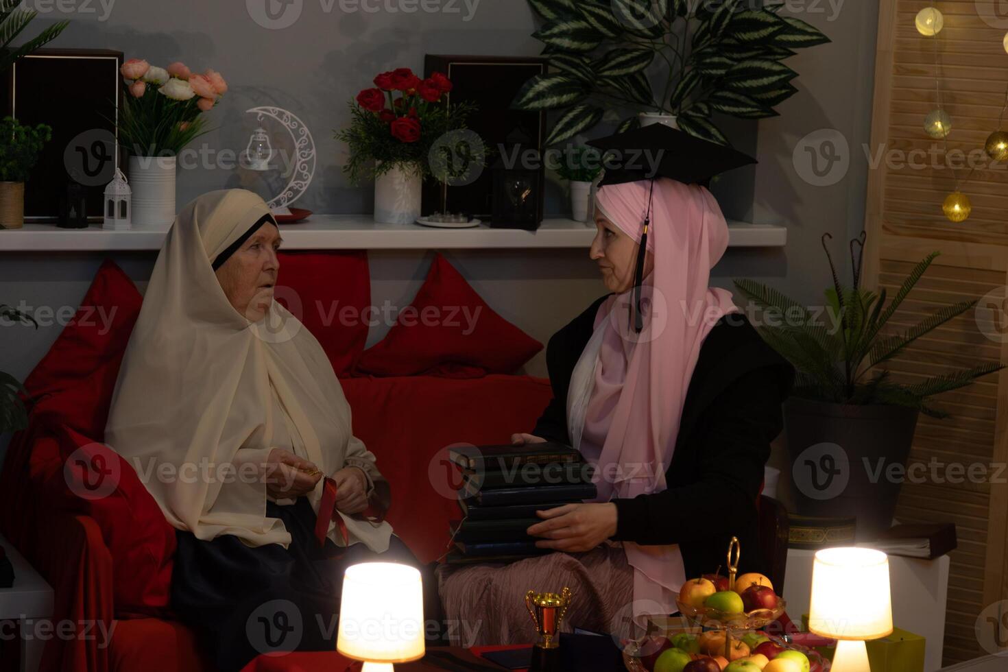 Two women sitting on a couch photo