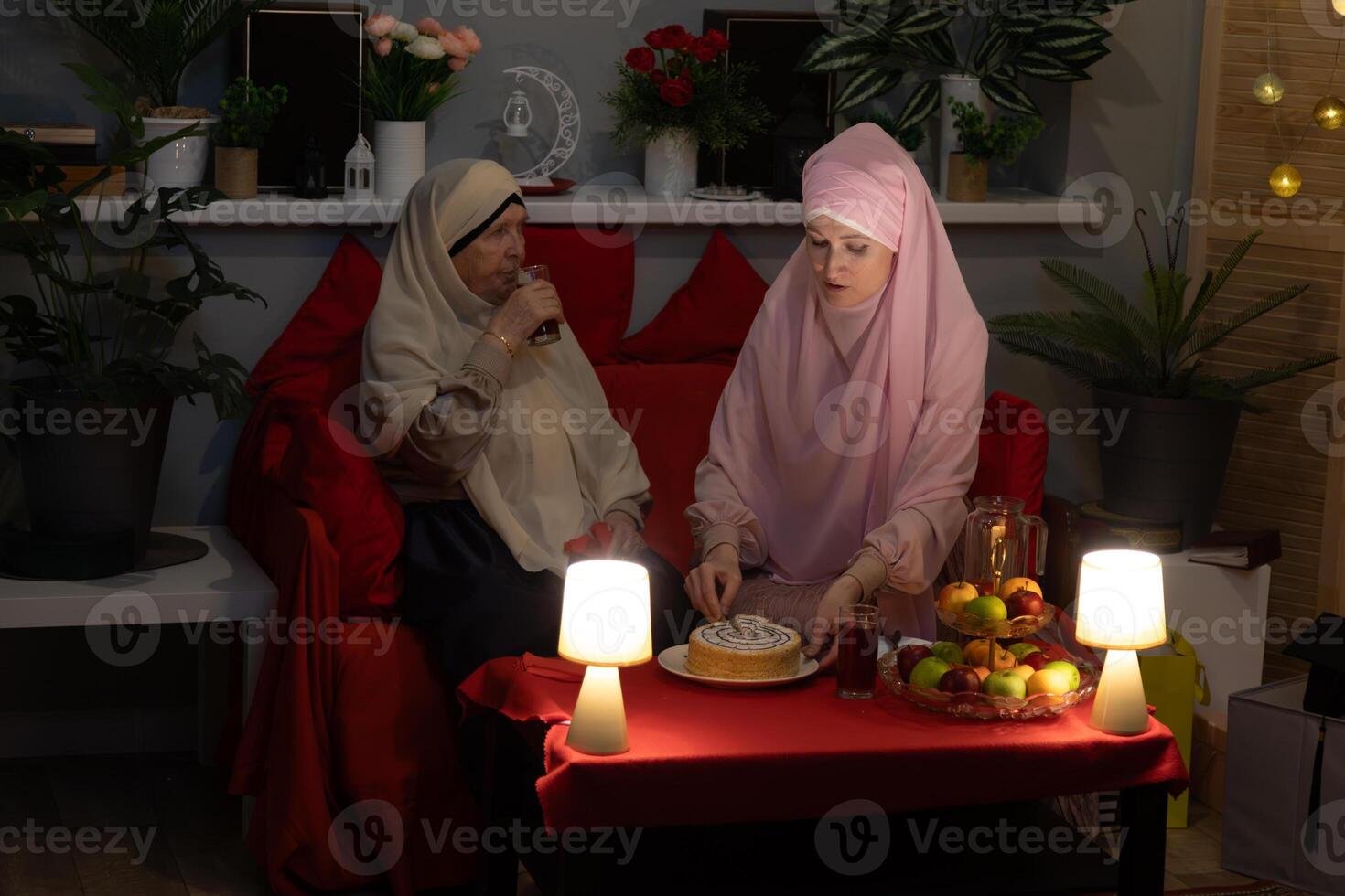 Two women sitting on a couch photo