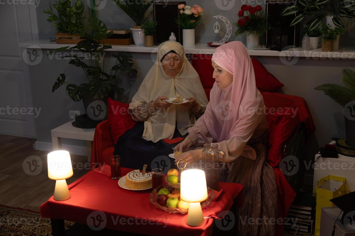 Two women sitting on a couch photo