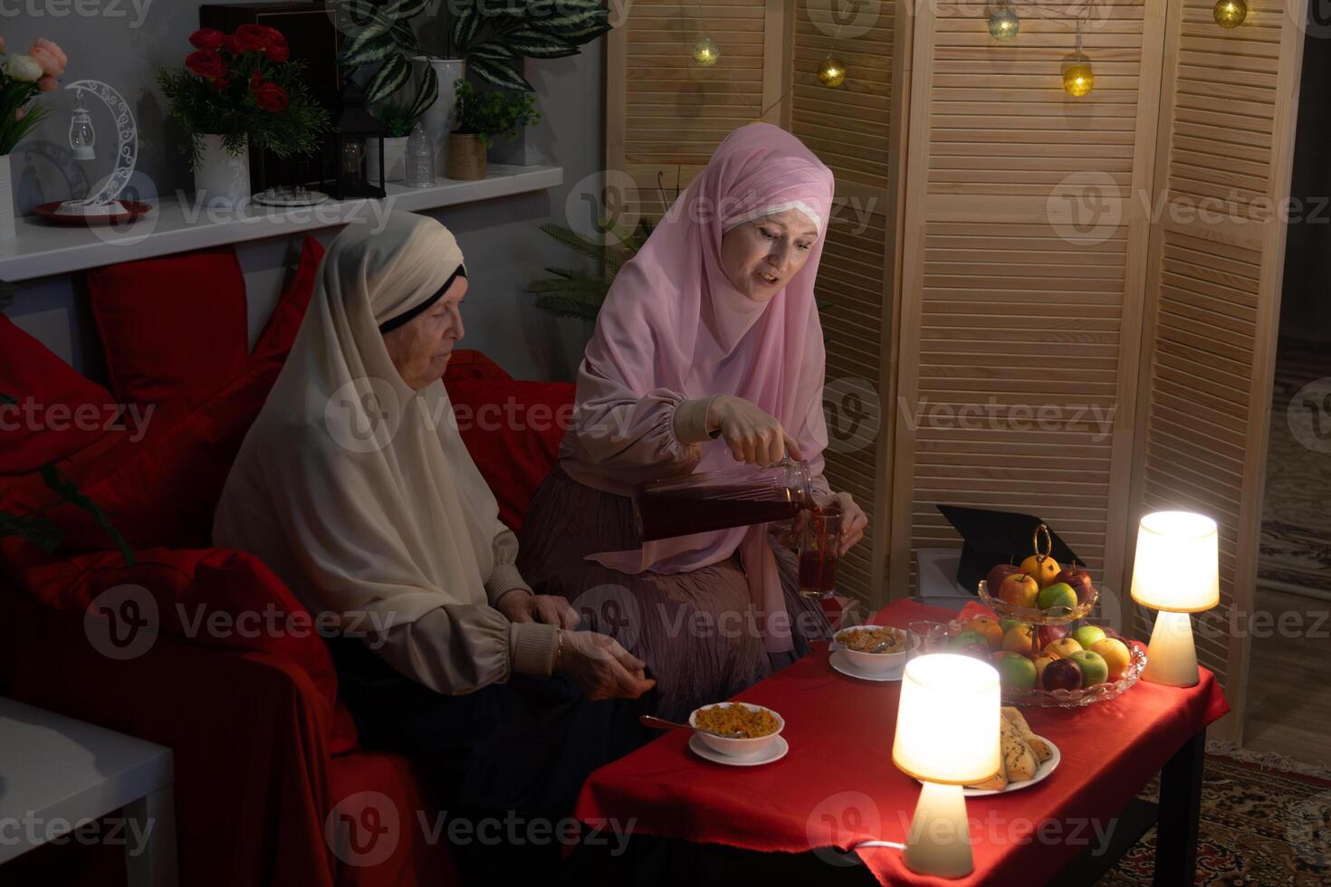 Two women sitting on a couch photo