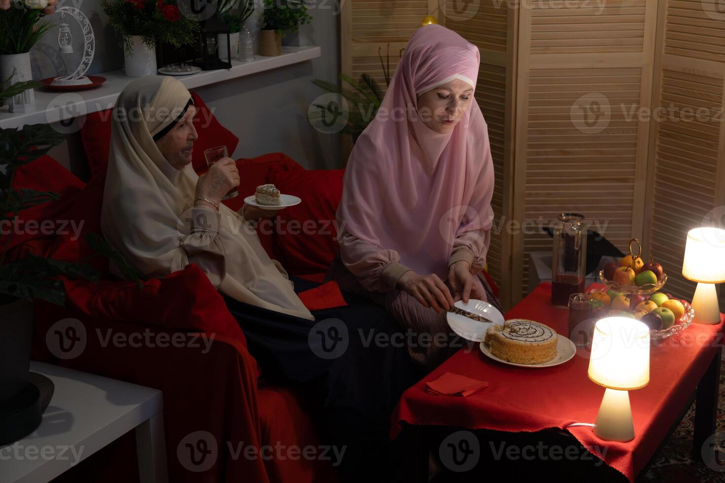 Two women sitting on a couch photo