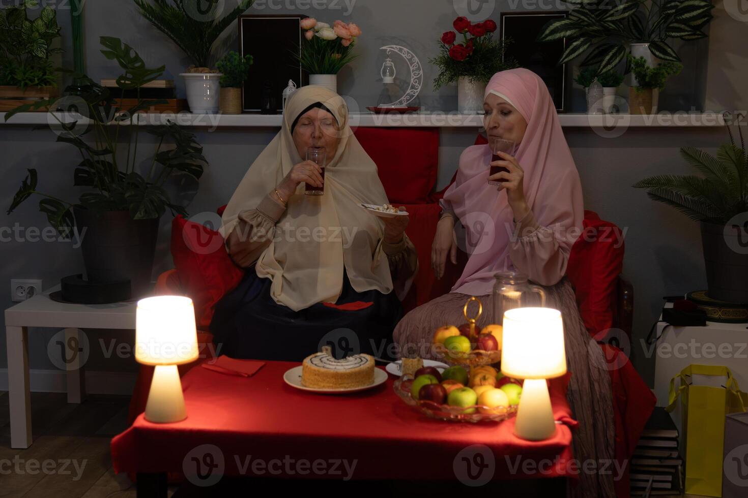 Two women sitting on a couch photo