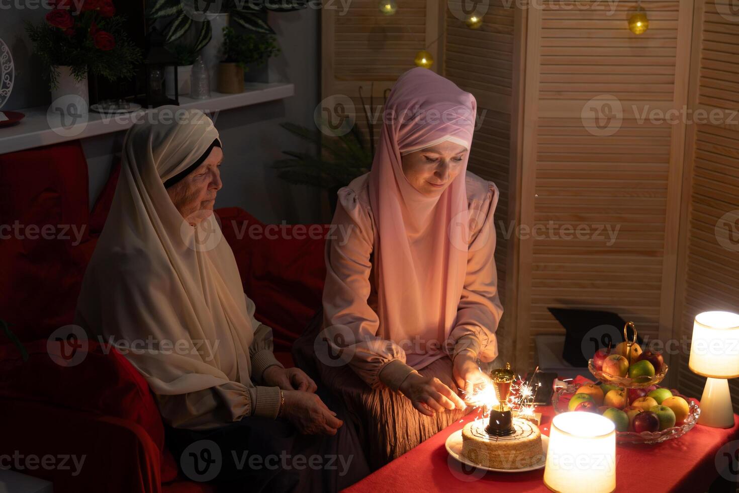Two women sitting on a couch photo