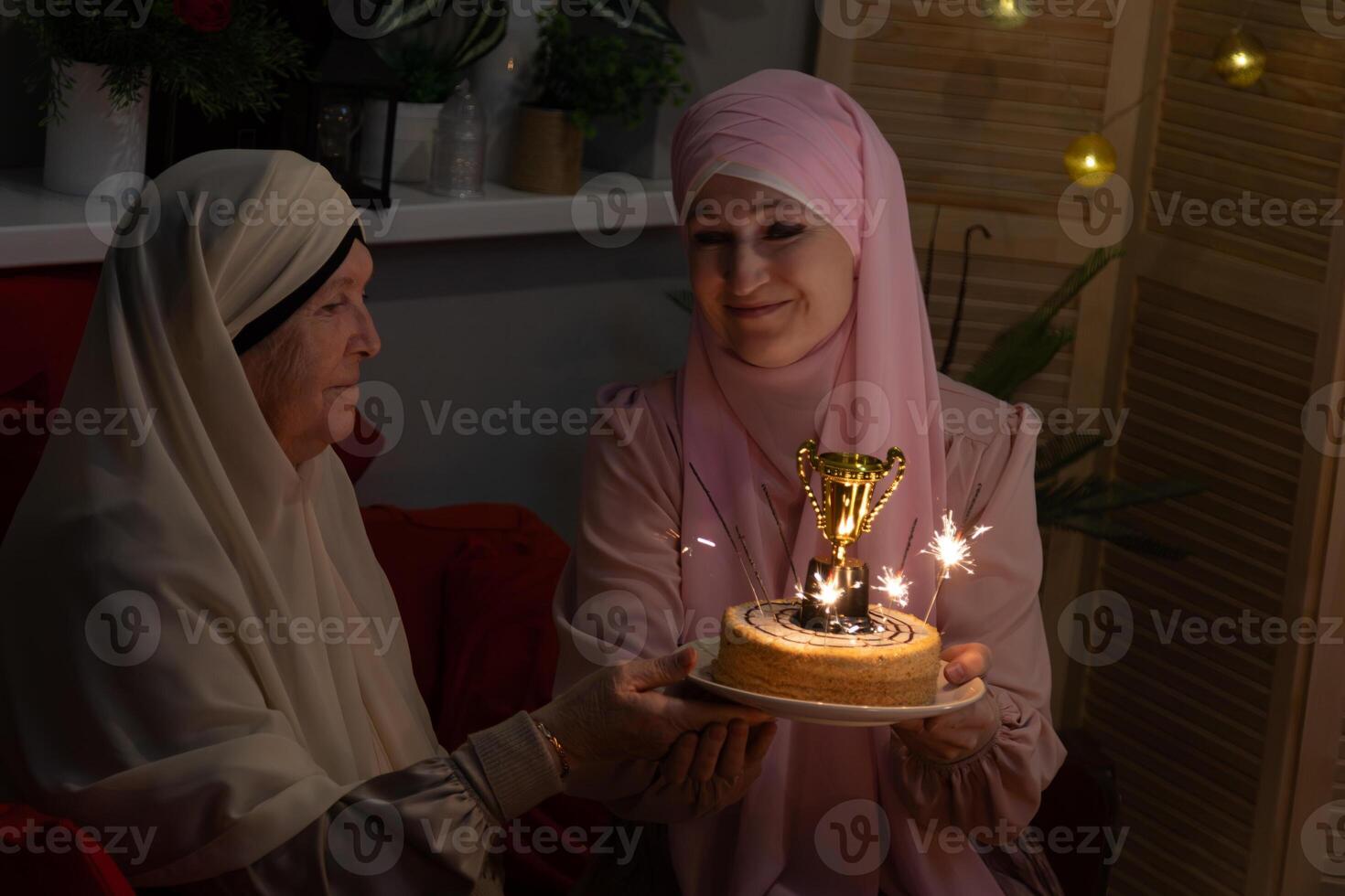 A woman holding a cake with sparklers photo