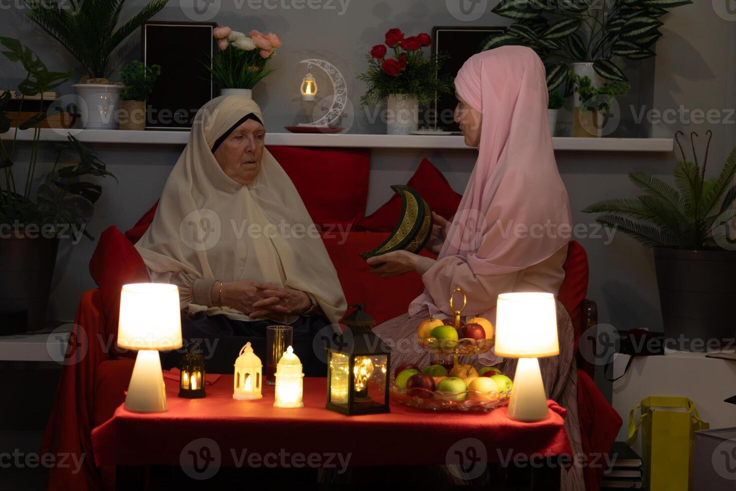 Two women sitting on a couch photo