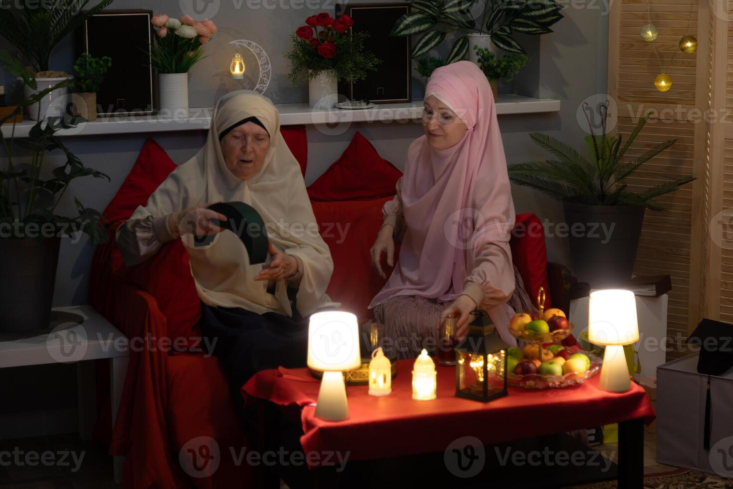 Two women sitting on a couch photo