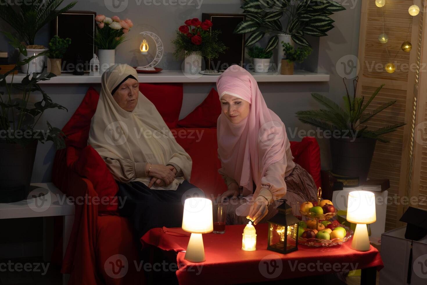 Two women sitting on a couch photo
