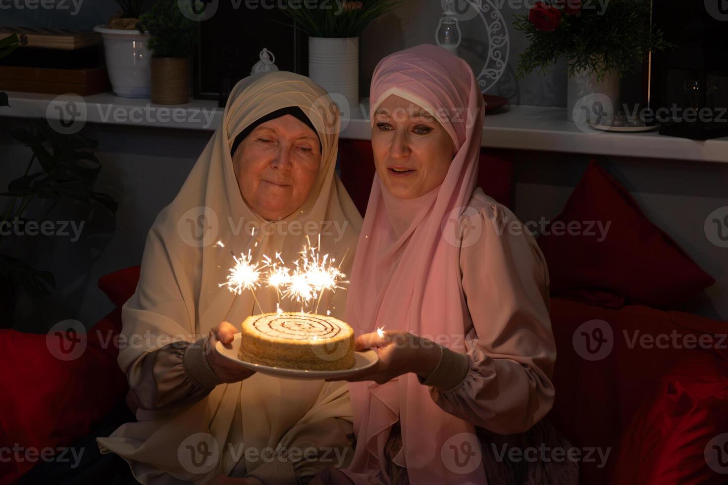 Two women sitting on a couch photo