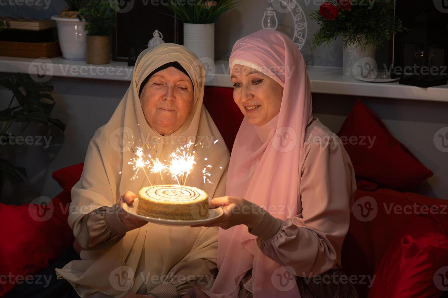 Two women sitting on a couch photo