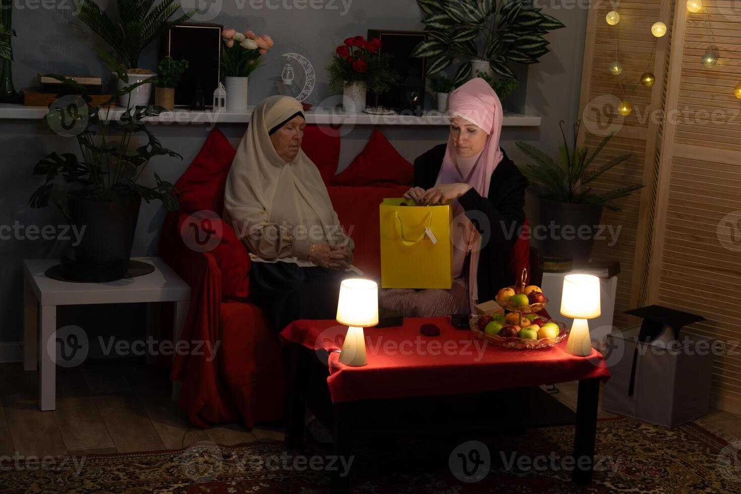 Two women sitting on a couch photo