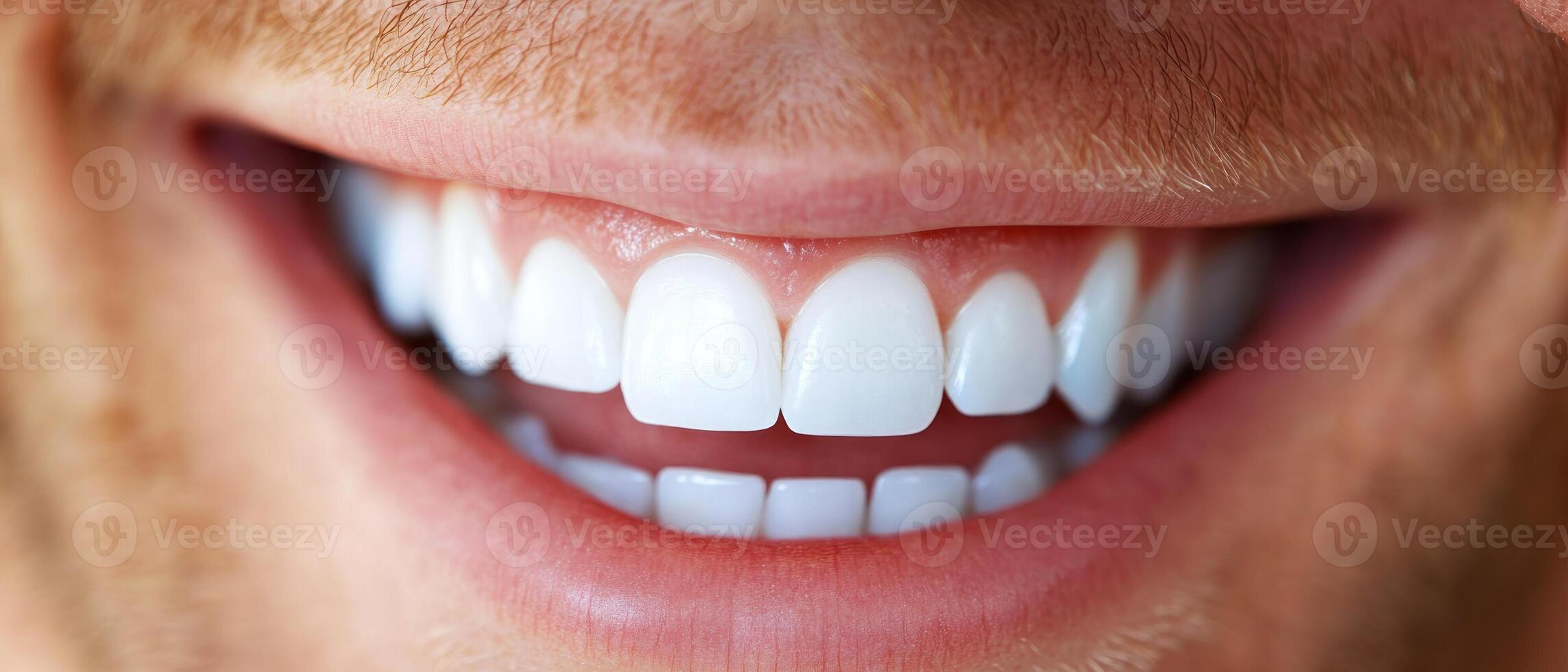 A man with a broad smile displays his white teeth, reflecting positive energy and good dental care in bright light photo