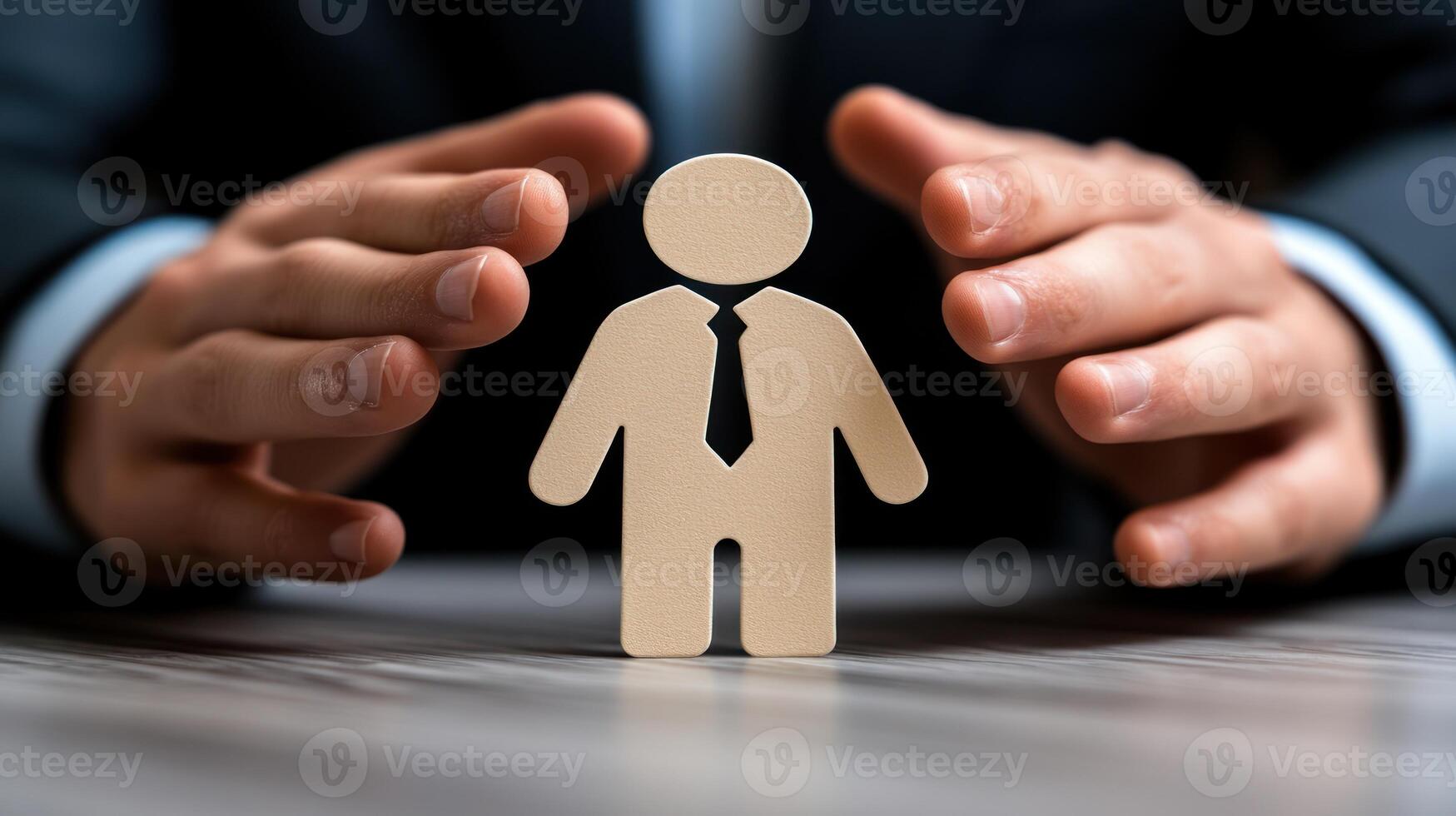 A businessman gestures protectively around a wooden figure, representing support during a corporate discussion photo