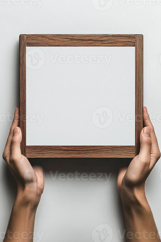 A person is presenting a blank whiteboard in a neutral setting, ready for display or creative use photo