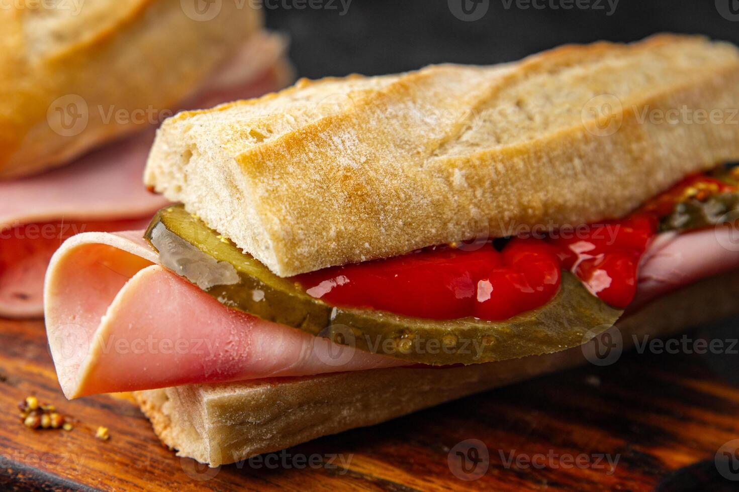 Sandwich ham, baguette, pickle cucumber, tomato sauce, mustard fast food fresh tasty food dish delicious gourmet food background on the table rustic food top view copy space photo