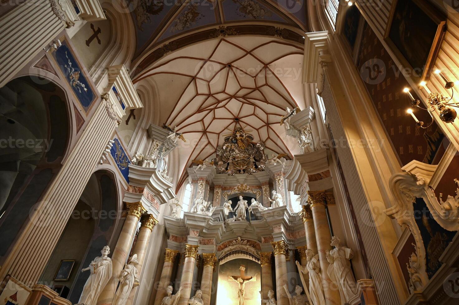 the interior of a church with statues and a ceiling photo