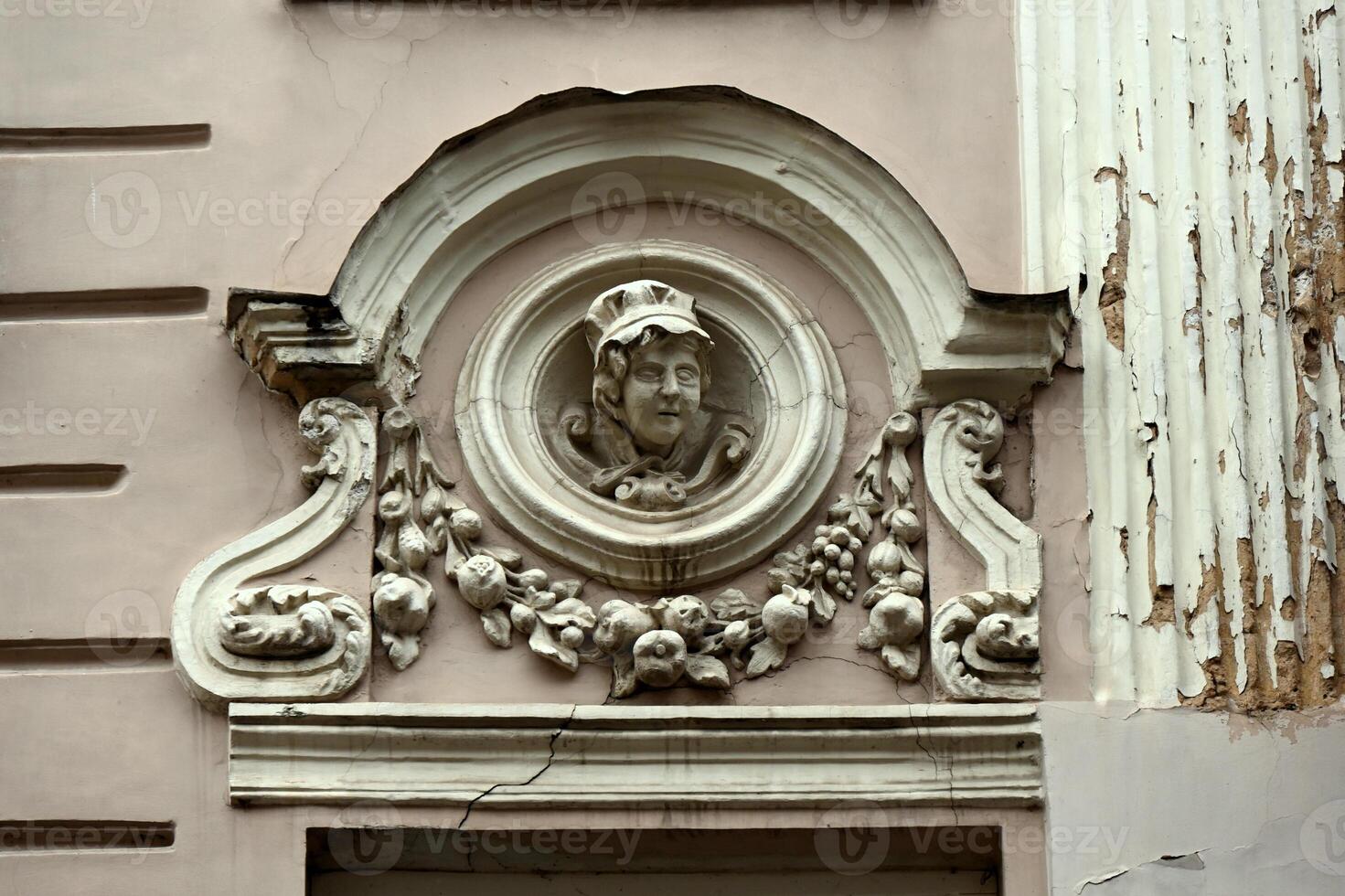 a decorative face on the side of a building photo