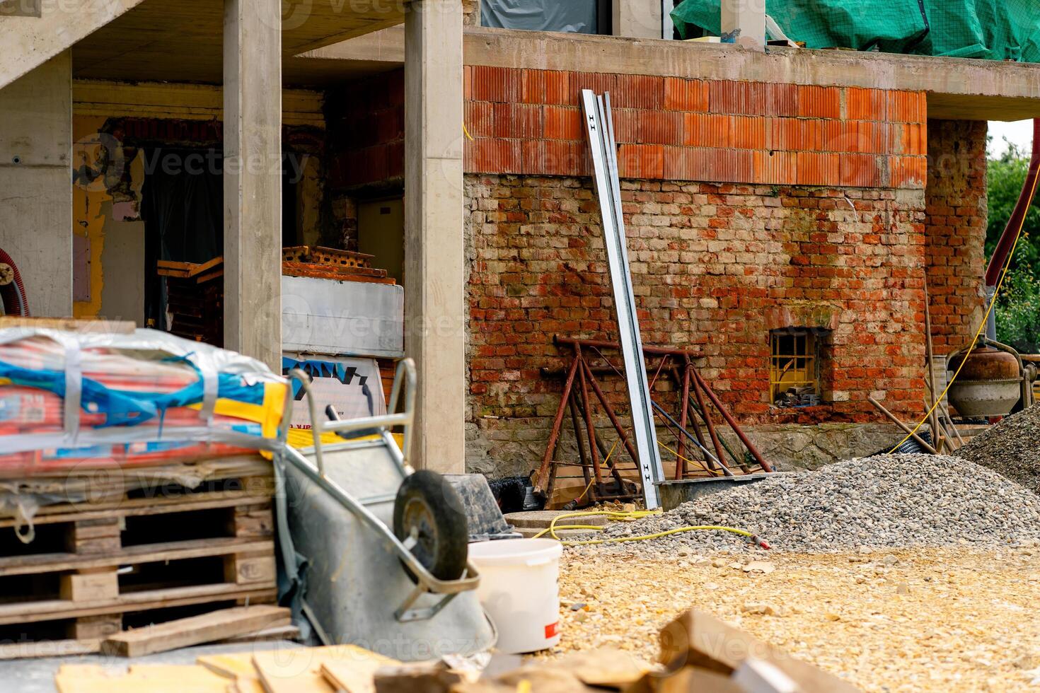 Various building materials and fixtures near a house under construction photo