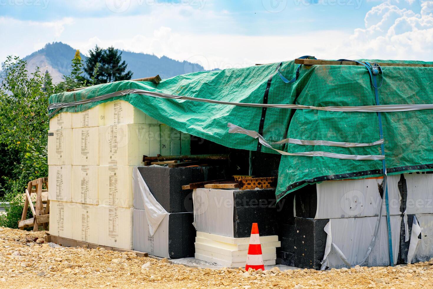 Various building materials and fixtures near a house under construction photo