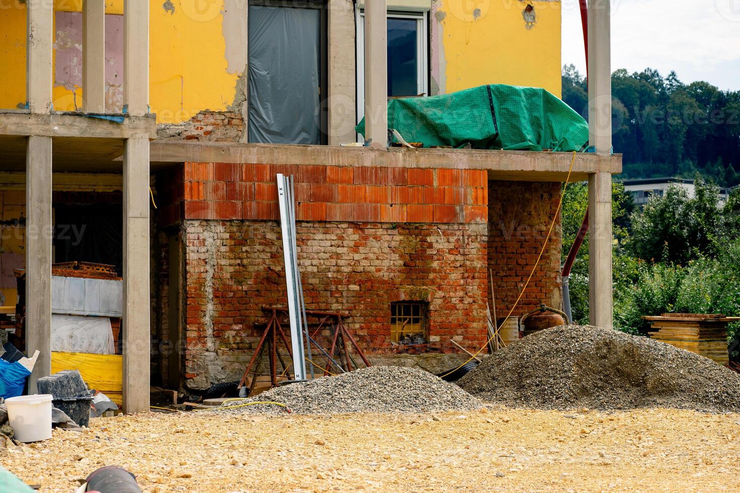 Various building materials and fixtures near a house under construction photo