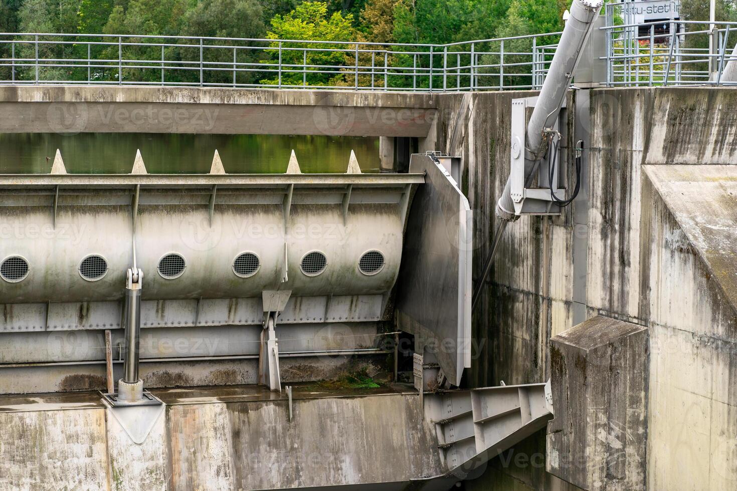 View of a closed spillway on a small dam on a river photo