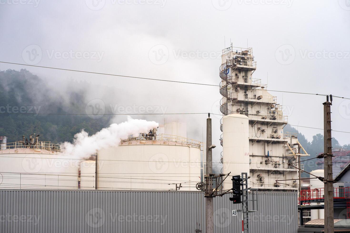 Industrial metallurgical plant in the morning fog. Emissions over the plant photo