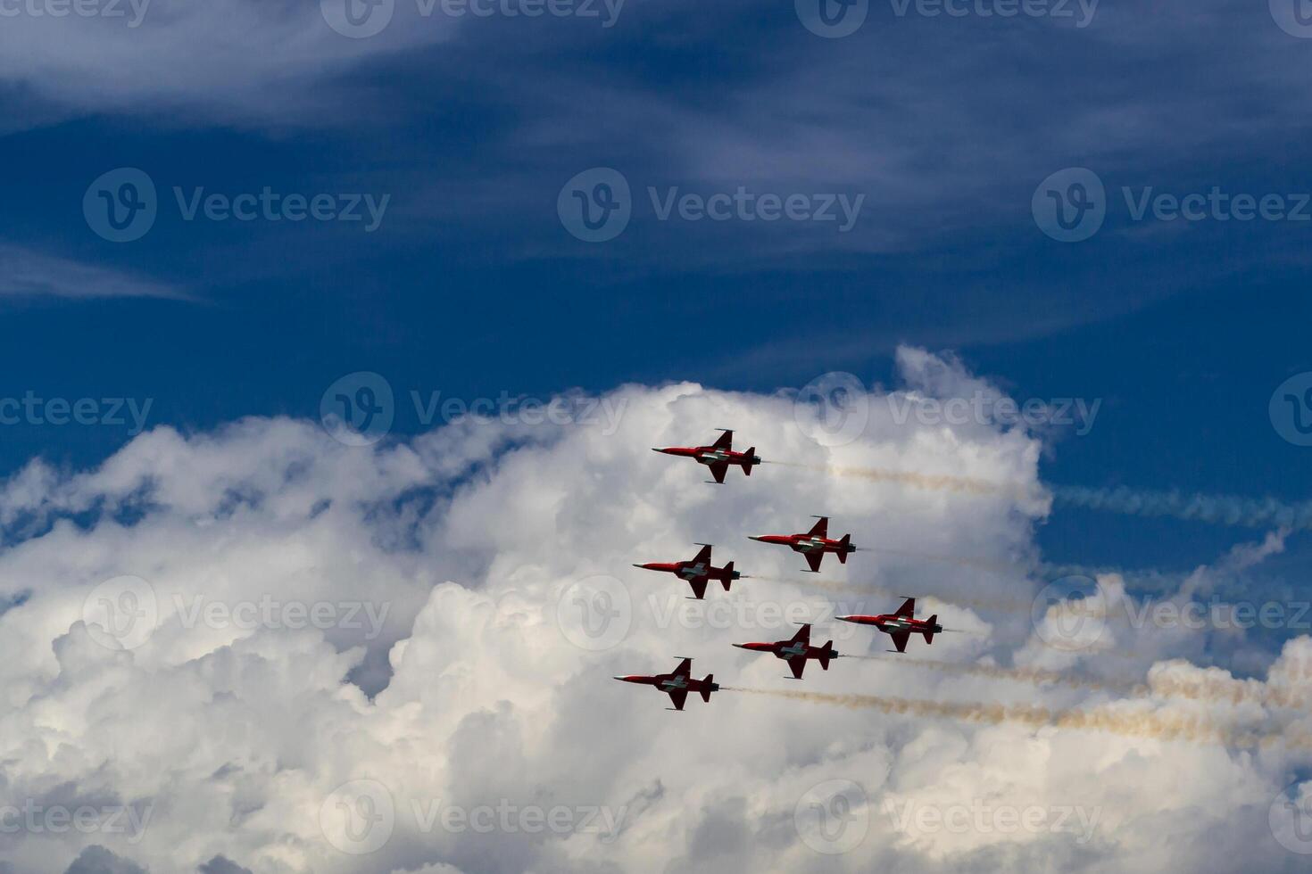 Six Swiss army planes against a blue sky and white clouds photo