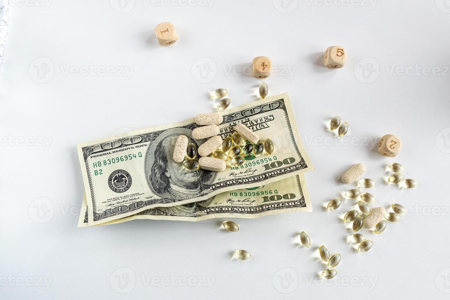 Jelly capsules and hard tablets of vitamin D on dollar bills on a white table photo