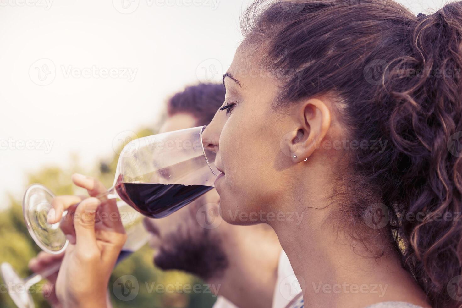profile portrait of young couple toasts at sunset photo