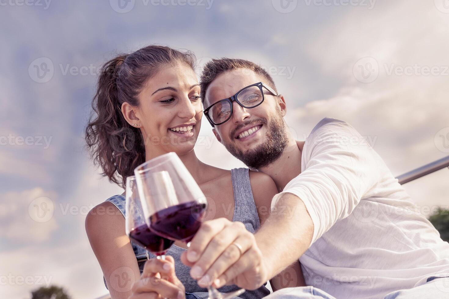 young couple farmers toasts in their vineyard photo