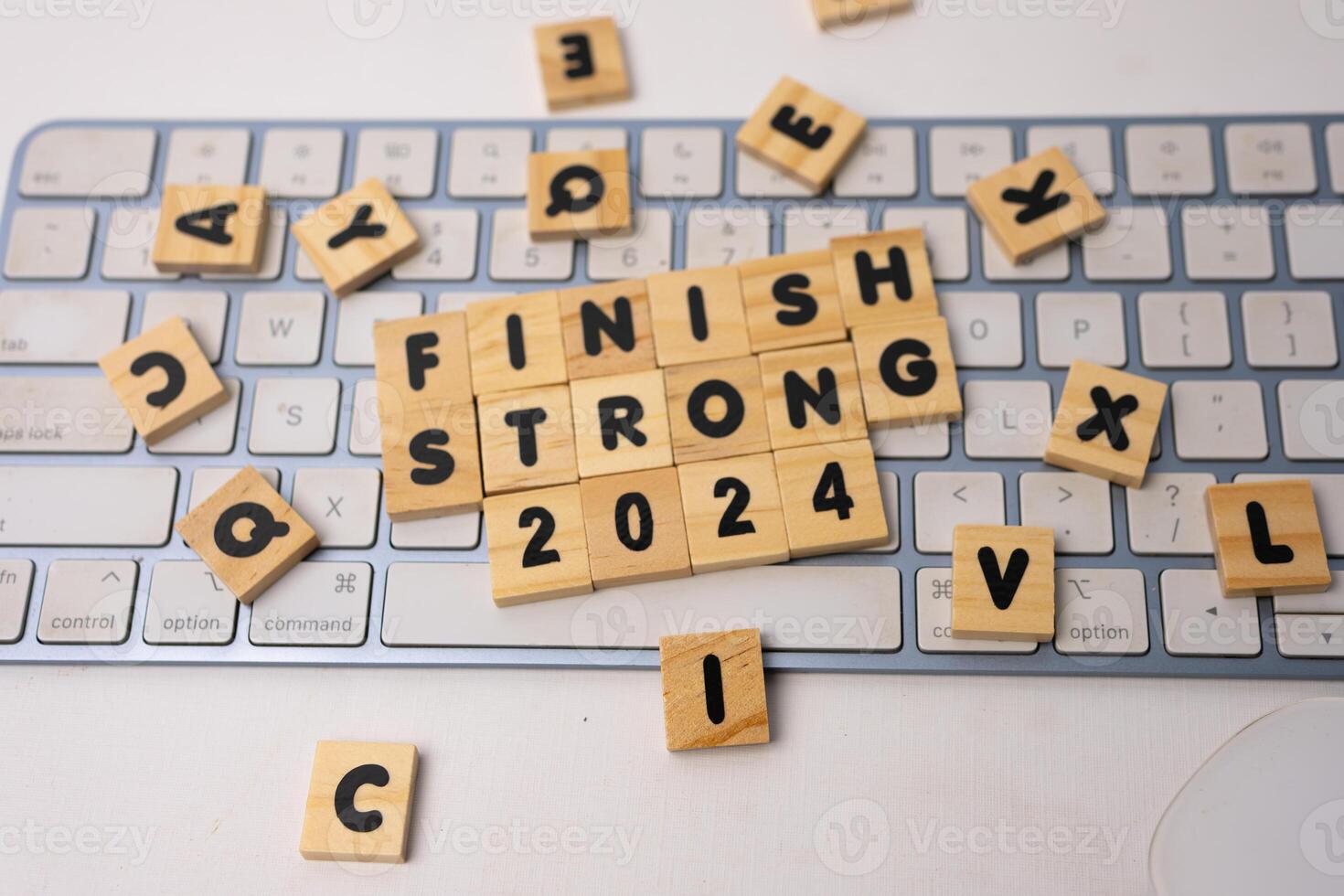 the wooden box says finish strong 2024 on top of white keyboard photo