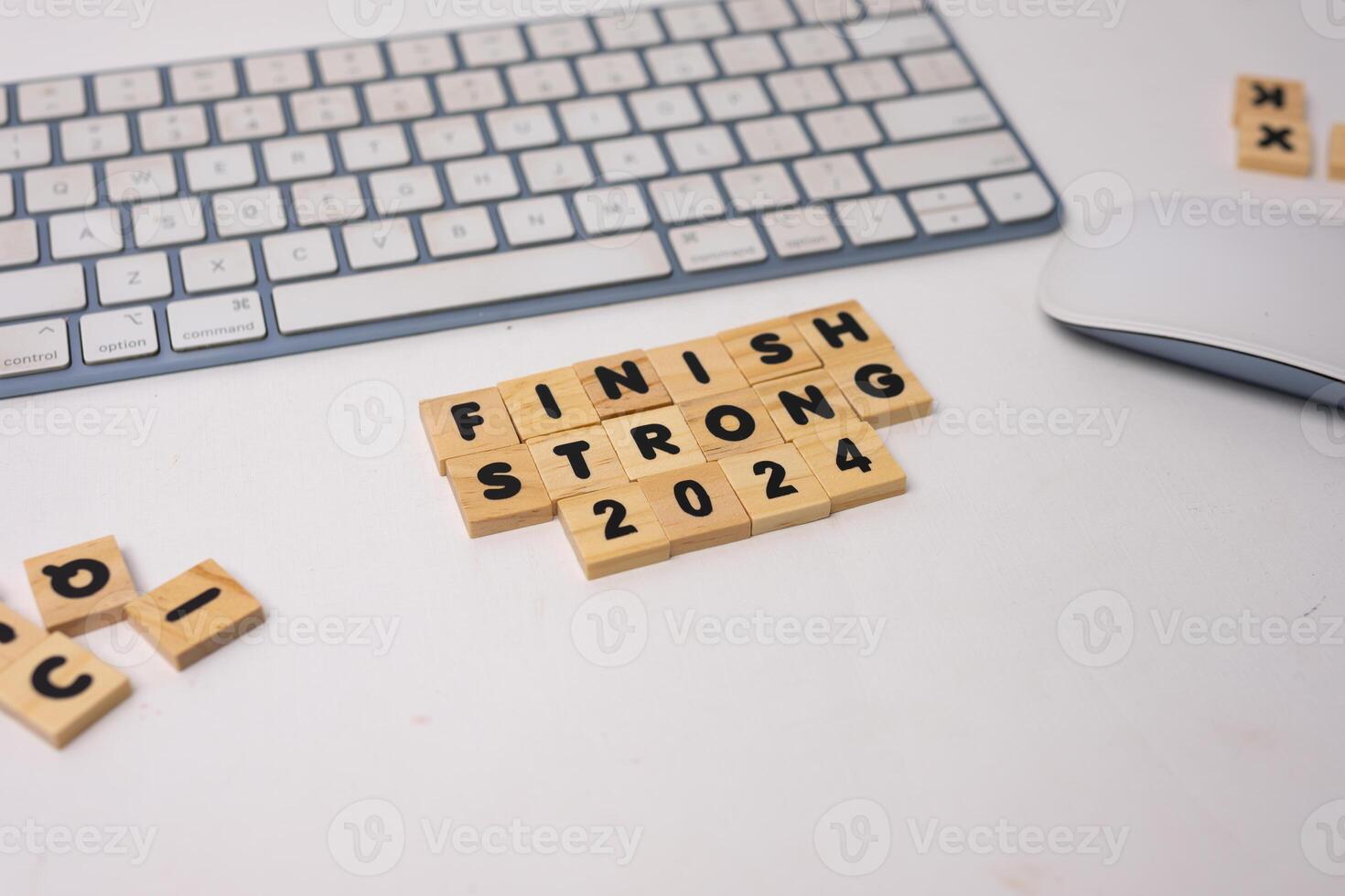 the wooden box says finish strong 2024 on top of white desk, diagonal view photo