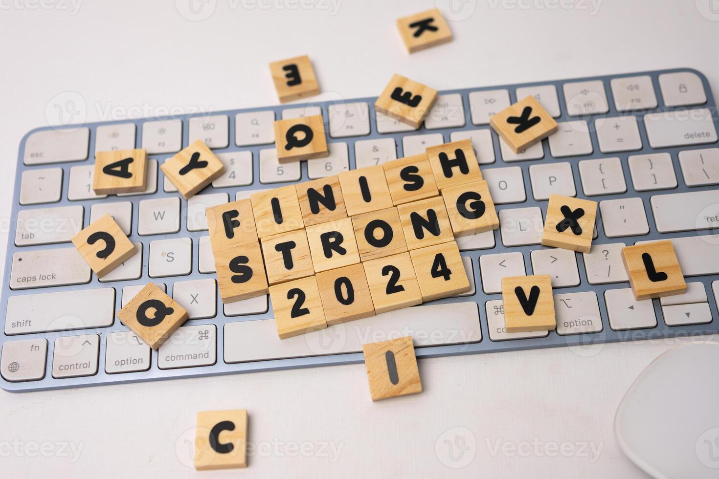 the wooden box says finish strong 2024 on top of keyboard photo