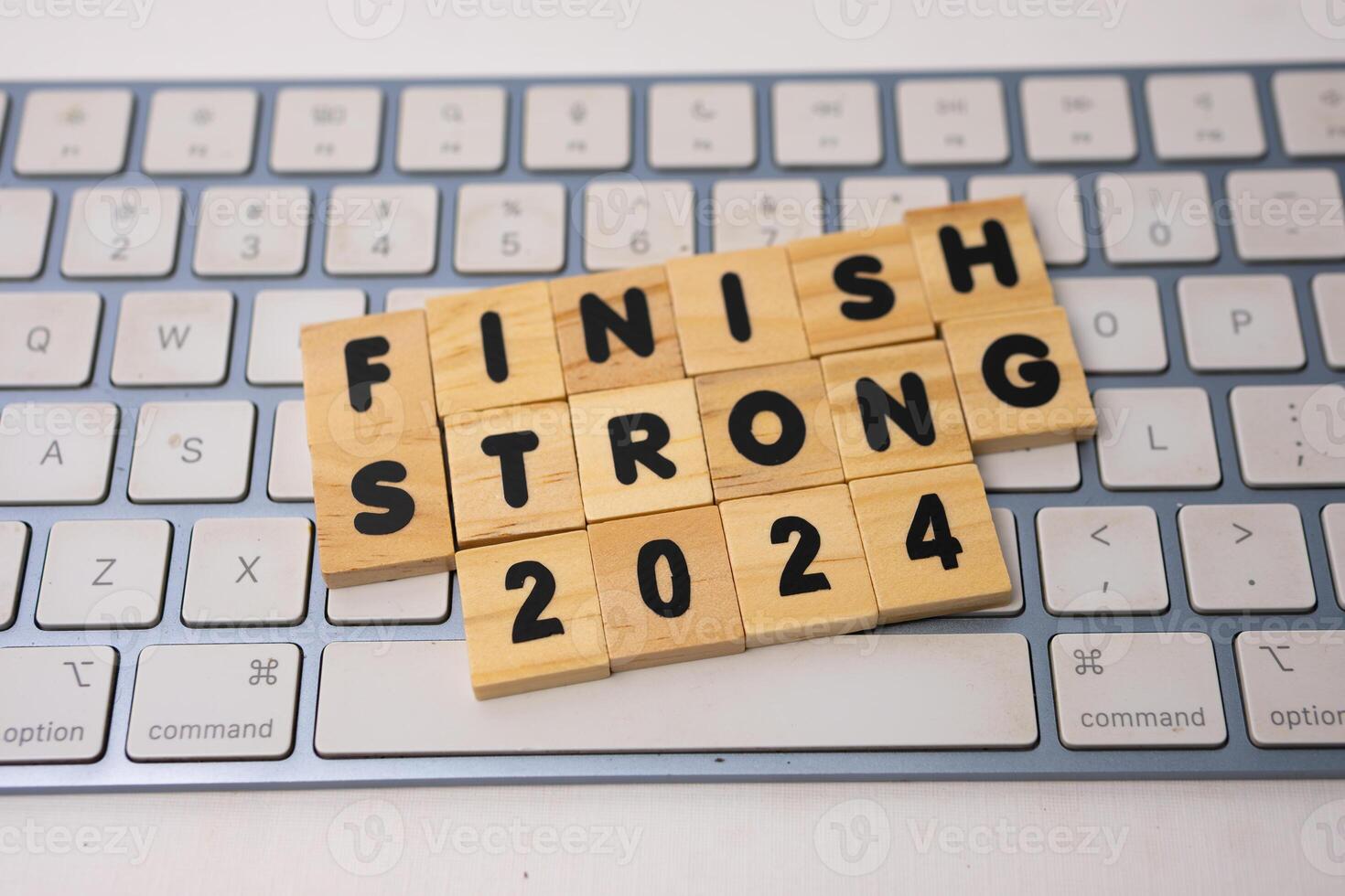 the wooden box says finish strong 2024 on top of keyboard photo