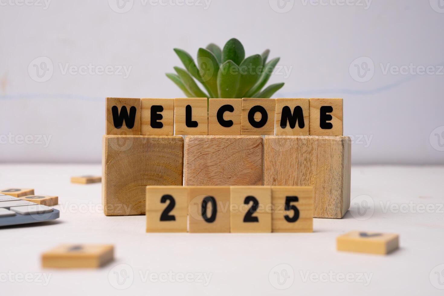 welcome 2025 on wooden blocks standing on a white desk photo