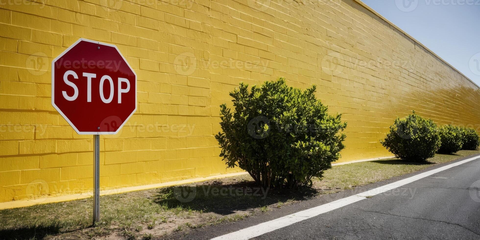 A stop sign is in front of a yellow wall photo