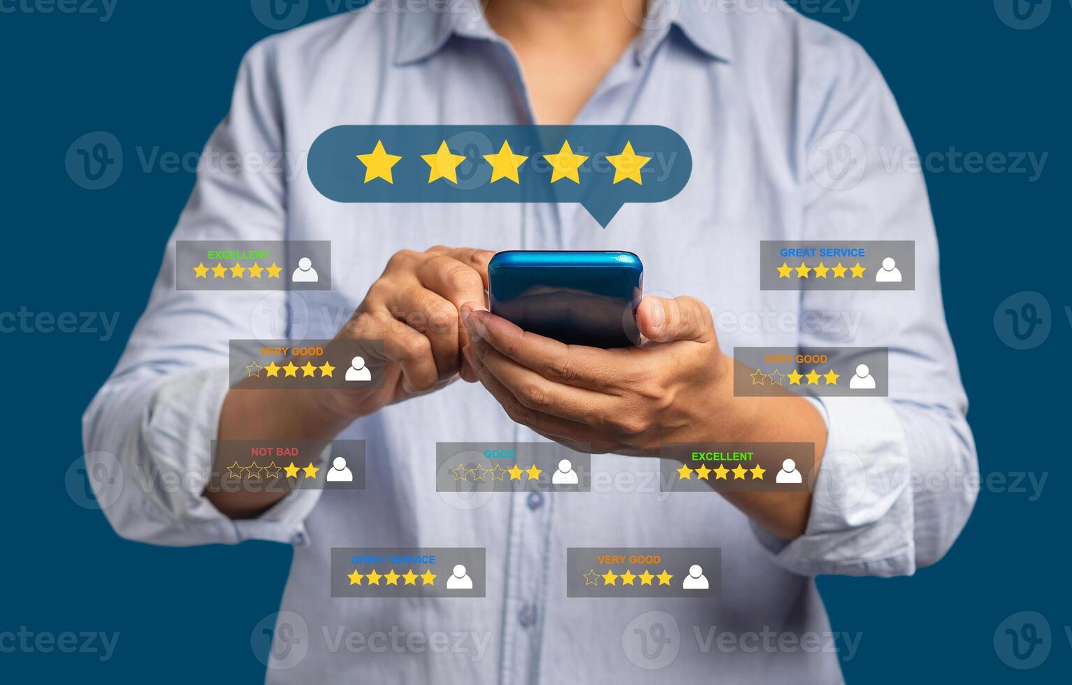 Satisfaction and feedback surveys. A man in a blue shirt using a smartphone gives the five-star icon a rating of very impressed for service while standing over a red background photo
