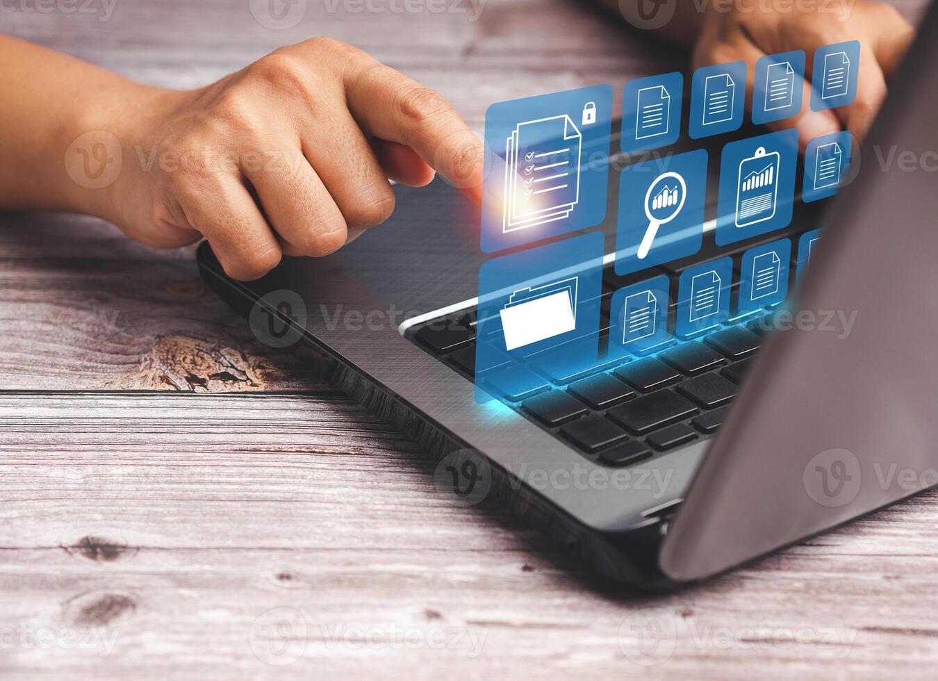 Businessman working at a laptop and digital documents on a virtual screen photo