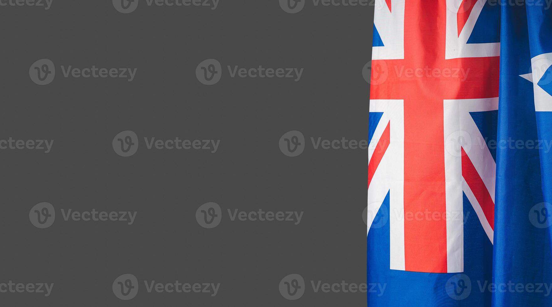 Close-up of the Australian flag is on the right side on a gray background photo