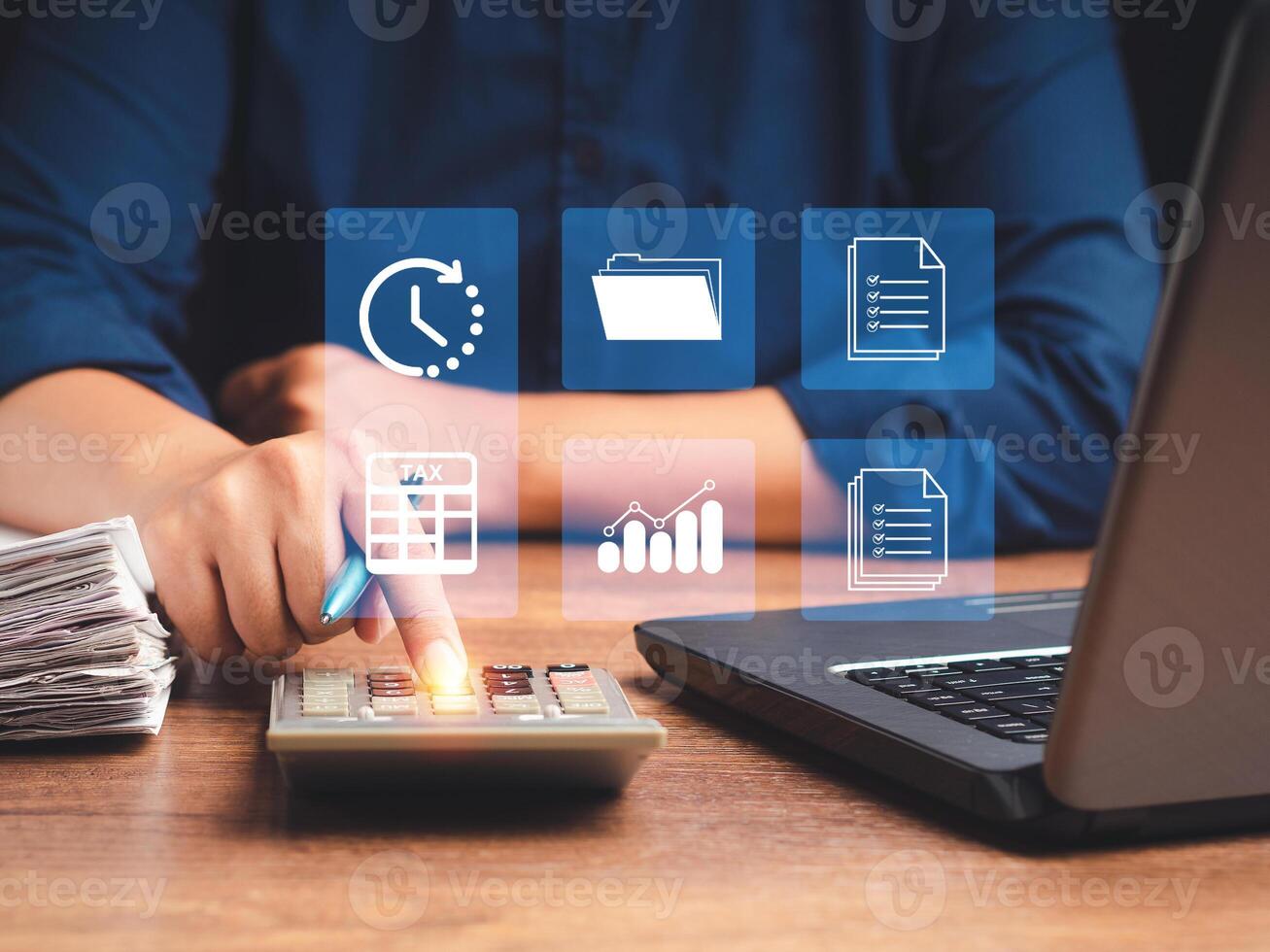 Tax day concept. Man using a calculator to calculate tax while sitting in the office photo