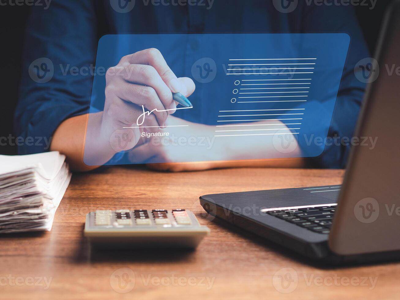 A businessman uses a pen to sign electronic documents on digital documents on a virtual screen. Electronic signature and paperless office concept photo