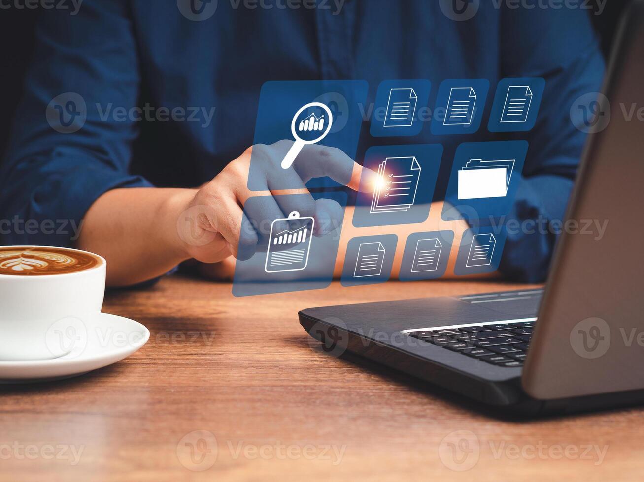 Businessman working at digital documents on a virtual screen while sitting in the office photo