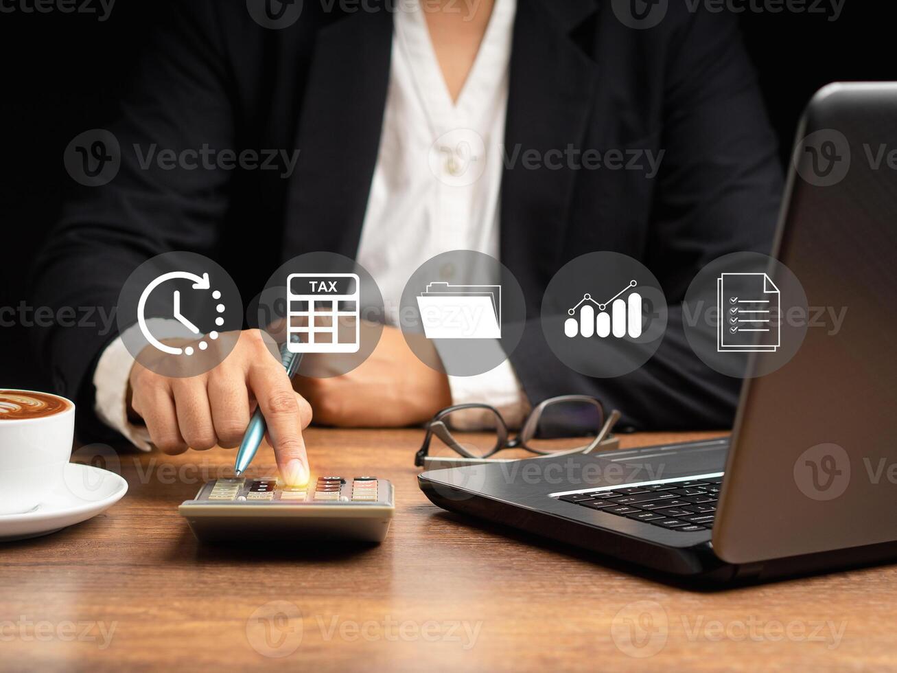 Tax day concept. Man using a calculator to calculate tax while sitting in the office photo